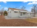 Charming home featuring new solar panels, light grey paint, and a cute covered front porch at 1100 S Quitman St, Denver, CO 80219