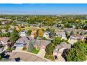 Expansive aerial view showcasing the neighborhood, surrounding greenery, and distant mountain views at 2425 Waneka Lake Trl, Lafayette, CO 80026