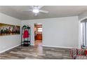 Living room with wood floors, adjacent to the kitchen with stainless steel appliances at 1925 S Irving St, Denver, CO 80219