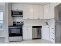 Updated kitchen featuring stainless steel appliances and white shaker cabinets at 155 S Sable Blvd # S26, Aurora, CO 80012