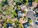 Aerial view of a well-maintained home with lush landscaping, a manicured lawn, and a cul-de-sac driveway at 10915 Acadia Ln, Parker, CO 80138