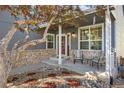 Cozy front porch with stone accents, comfortable seating, and tasteful landscaping creating an inviting entrance at 10915 Acadia Ln, Parker, CO 80138