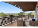 Comfortable deck with mountain views featuring wicker furniture and a wood ceiling at 20243 High Pines Dr, Monument, CO 80132