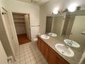 Bathroom with double vanity and linen closet at 2960 Inca St # 319, Denver, CO 80202