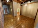 Hardwood floor living room with exposed brick wall at 2960 Inca St # 319, Denver, CO 80202