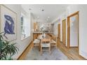 Open dining area with light wood floors, adjacent to a modern kitchen with ample natural light at 4632 14Th St, Boulder, CO 80304