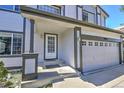 Close up view of the inviting front entrance with well maintained garage door and number 9265 at 9265 Roadrunner St, Highlands Ranch, CO 80129