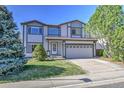 Inviting two-story home with a well-maintained lawn and an attached two-car garage at 9265 Roadrunner St, Highlands Ranch, CO 80129