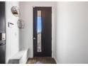 Modern entryway with a black door, white walls, wood floors, and minimalist decor at 2602 W 24Th Ave # 6, Denver, CO 80211