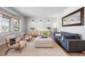 Cozy living room with natural light, plush seating, neutral tones, and stylish decor at 17378 W 78Th Dr, Arvada, CO 80007
