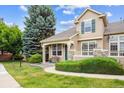 Well-maintained home with lush green lawn and mature trees enhancing curb appeal at 10166 Grove Loop # D, Westminster, CO 80031