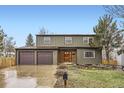 Charming two-story home with a well-manicured lawn, complemented by a spacious three-car garage at 11864 E Idaho Dr, Aurora, CO 80012