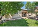 View of house's outdoor space including trees and a covered porch with seating at 8582 E 148Th Ln, Thornton, CO 80602