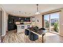 Modern kitchen with an island and stainless steel appliances at 10870 Unity Way, Commerce City, CO 80022