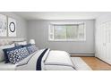 Bright bedroom featuring a bay window, light walls, plush bedding, and a door to the ensuite at 550 E 12Th Ave # 209, Denver, CO 80203