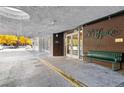 Building entrance with a sign reading 'Penn Square 550' and a green bench at 550 E 12Th Ave # 209, Denver, CO 80203