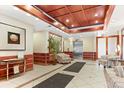 Condo building lobby with wood trim, tile floors, and comfortable seating at 550 E 12Th Ave # 209, Denver, CO 80203