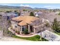 Wide aerial showcasing a two-story house with a three car garage and pristine landscaping at 8487 S Nelson St, Littleton, CO 80127