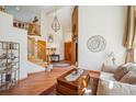 Bright foyer featuring hardwood floors, an open staircase, and a statement chandelier at 8487 S Nelson St, Littleton, CO 80127