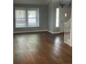 Sun-filled living room features gleaming hardwood floors and neutral paint at 14503 E Wagon Trail Dr, Aurora, CO 80015