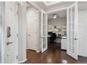 Welcoming entryway with hardwood floors, open French doors to an office, and neutral wall paint at 15079 E Poundstone Pl, Aurora, CO 80015