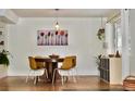 Bright dining room with modern lighting, stylish chairs, hardwood floors, and natural light at 3240 Folsom St, Boulder, CO 80304