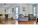 Bright living room featuring hardwood floors, a cozy seating area, and access to the front entrance at 3240 Folsom St, Boulder, CO 80304