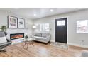 Cozy living room with a decorative fireplace, hardwood floors, and modern decor at 1724 W 40Th Ave, Denver, CO 80211