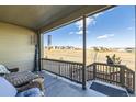 Relaxing covered patio with furniture overlooking the neighborhood landscape at 4051 Happy Hollow Dr, Castle Rock, CO 80104