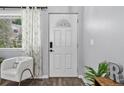 Bright foyer with decorative front door, chair, and hardwood floors at 4333 E Bennington Ave, Castle Rock, CO 80104