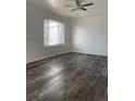 This clean bedroom has modern flooring, neutral paint, and a large window at 16289 E Wagontrail Dr, Aurora, CO 80015