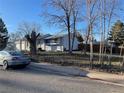 The exterior of this single-story home features a well-maintained front yard at 16289 E Wagontrail Dr, Aurora, CO 80015