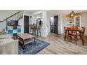 Cozy living room with hardwood floors, modern furnishings, and seamless transition to dining area at 9195 E Lehigh Ave # 162, Denver, CO 80237