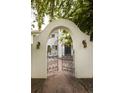 Charming gated entrance features ornate ironwork and stone pathway at 5800 E 6Th Avenue Pkwy, Denver, CO 80220