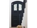 Elegant front door with stained glass panel adjacent to staircase at 5800 E 6Th Avenue Pkwy, Denver, CO 80220
