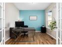 Comfortable office space with hardwood floors, large window, and a modern desk setup perfect for working from home at 35 N Newcastle Ct, Aurora, CO 80018