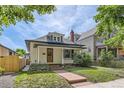 Charming home with a well-maintained yard, red stone pathway, and inviting covered porch at 1012 Fillmore St, Denver, CO 80206