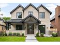 Traditional two-story brick home with a covered porch and manicured lawn, professionally landscaped at 2237 S Madison St, Denver, CO 80210