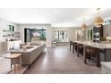 Open concept living area and kitchen with stainless appliances, large island, and sliding glass doors at 2237 S Madison St, Denver, CO 80210