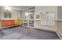 Lobby area with seating and a wall-mounted set of mailboxes at 6940 E Girard Ave # 307, Denver, CO 80224