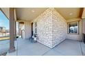 Inviting covered front porch with stone detailing and a cozy seating area for relaxing outdoors at 420 Pleades Pl, Erie, CO 80516