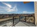 Balcony view overlooking a scenic landscape with clear glass railings and a modern design at 1208 N Quitman St # 405, Denver, CO 80204