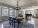 Bright and airy dining room features an elegant chandelier, and view from large windows at 126 Mc Intyre Circle, Golden, CO 80401