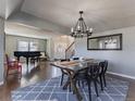 Open-concept dining room with hardwood floors, natural light, and an elegant chandelier at 126 Mc Intyre Circle, Golden, CO 80401