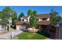 Charming two-story home featuring a brick facade, well-maintained lawn, and an attached two-car garage at 941 E 130Th Cir, Thornton, CO 80241