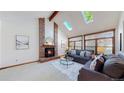 Cozy living room with a brick fireplace, plush seating, lots of natural light, and neutral decor at 941 E 130Th Cir, Thornton, CO 80241