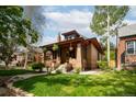 Brick home with lawn and landscaping in front at 1169 Cook St, Denver, CO 80206