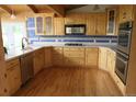 Spacious kitchen with custom wood cabinets, double ovens, and quartz countertops at 13168 W 62Nd Dr, Arvada, CO 80004