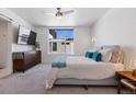 Serene bedroom featuring a ceiling fan, plush carpet, and large window at 3036 Wilson Ct # 5, Denver, CO 80205