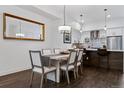Light-filled dining room featuring a modern chandelier, large mirror and wood floors at 3036 Wilson Ct # 5, Denver, CO 80205